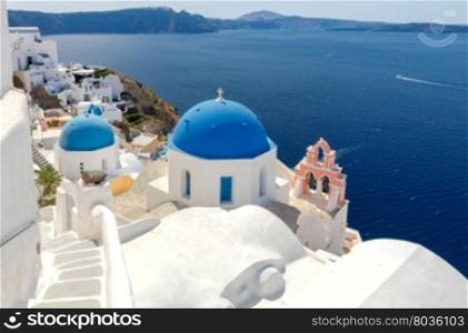 Oia. Traditional architecture of Santorini.. Blue dome on traditional Greek church in the village of Oia.