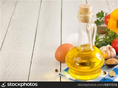 oil and food ingredients, spice on wooden background