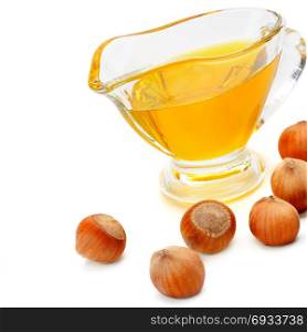 Oil and fruit hazelnut isolated on white background. Free space for text.