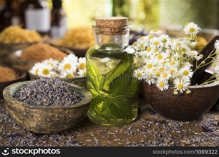 Oil and Natural medicine, wooden table background