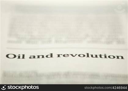 Oil and revolution text on newspaper