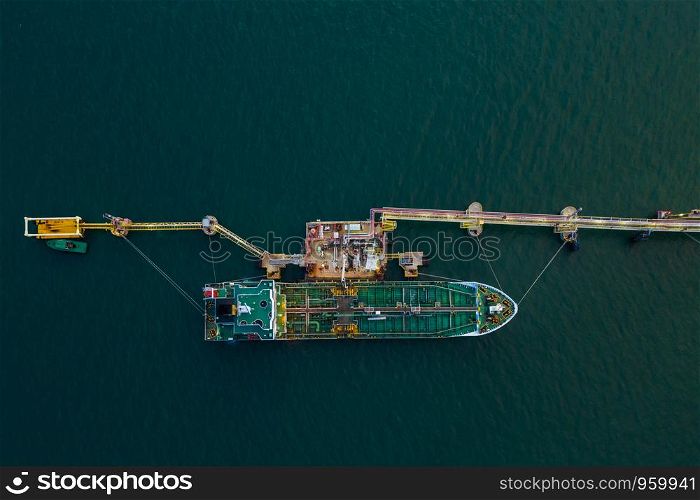 oil and tanker ship on the sea port oil and petrochemical product export business from refinery industry Thailand aerial top view at evening