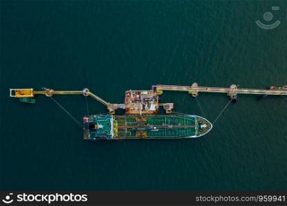 oil and tanker ship on the sea port oil and petrochemical product export business from refinery industry Thailand aerial top view at evening