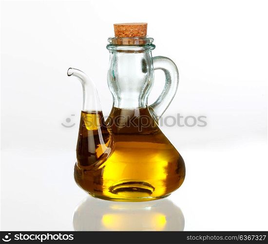 Oil bottle with the golden juice of the olive isolated on white background