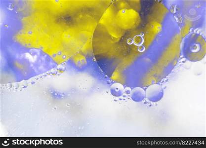 Oil bubbles close up. a circles of water macro. abstract light blue and yellow background. Oil bubbles close up. circles of water macro. abstract light blue and yellow background