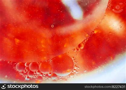 Oil bubbles close up. a circles of water macro. abstract orange and fiery red background. Oil bubbles close up. circles of water macro. abstract orange and fiery red background