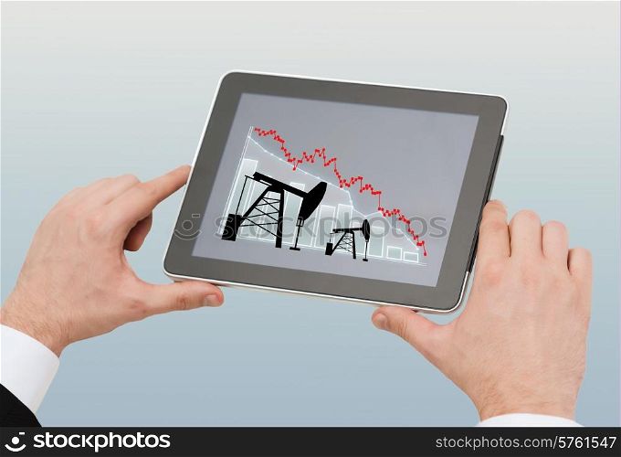oil business, energy crisis, people and technology concept - close up of man hands holding tablet pc computer with pump jacks and graph on screen over gray background