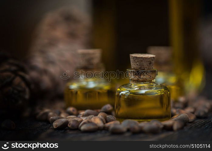 Oil of cedar nuts. Oil of cedar nuts on a dark wooden background