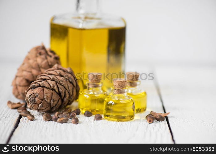 Oil of cedar nuts. Oil of cedar nuts on a white wooden background