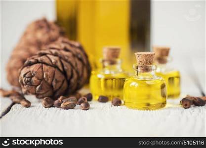Oil of cedar nuts. Oil of cedar nuts on a white wooden background