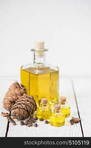 Oil of cedar nuts. Oil of cedar nuts on a white wooden background