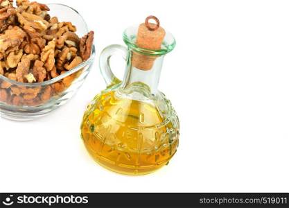 Oil of walnut and nut fruit isolated on white background. Free space for text.