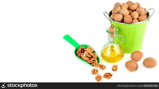 Oil of walnut and nut fruit isolated on white background. Free space for text. Wide photo.
