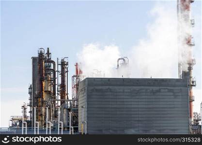 Oil petrochemical Factory plant with gas storage and structure of pipeline with smoke from smokestack in Kawasaki City near Tokyo Japan