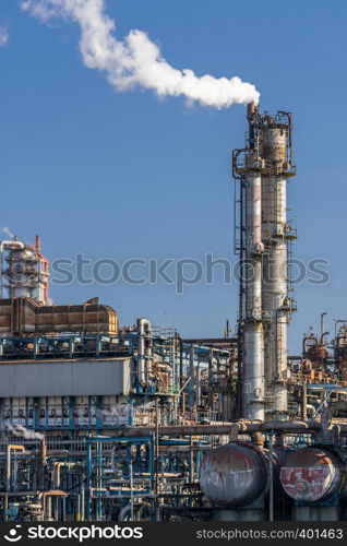 Oil petrochemical Factory plant with gas storage and structure of pipeline with smoke from smokestack in Kawasaki City near Tokyo Japan