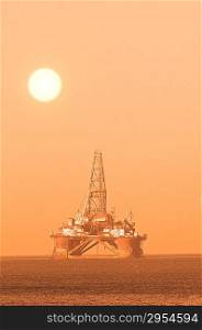 Oil platform during sunset