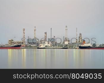 oil refinery along the river with reflection