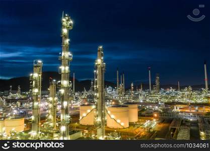 oil refinery and gas petrochemical industry with storage tanks steel pipeline area at twilight aerial view from drone in Thailand