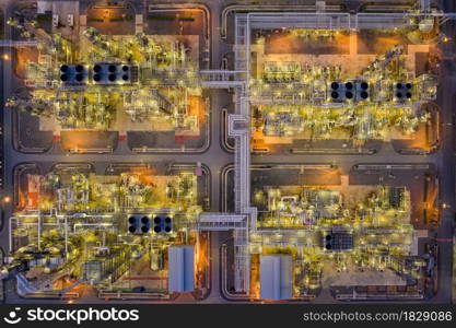 oil refinery and gas petrochemical industry with storage tanks steel pipeline area at twilight aerial view from drone in Thailand