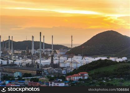 Oil refinery plant and oil storage tank in morning