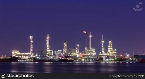Oil refinery plant illuminated at twilight in Bangkok, Thailand