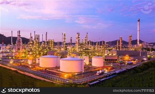 Oil? refinery? with oil storage tank and petrochemical? plant industrial background at twilight, Aerial view oil and gas refinery at twilight.