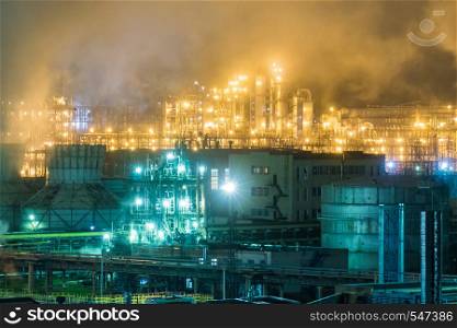 Oil refinery with pipes and distillation complexes at night.. Oil refinery with pipes and distillation complexes at night