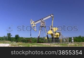 Oil Well on Plains Against Blue Sky