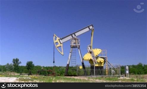 Oil Well on Plains Against Blue Sky