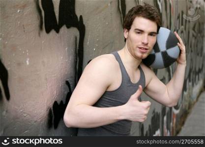 ok okay finger gesture young male street basket player on silver wall