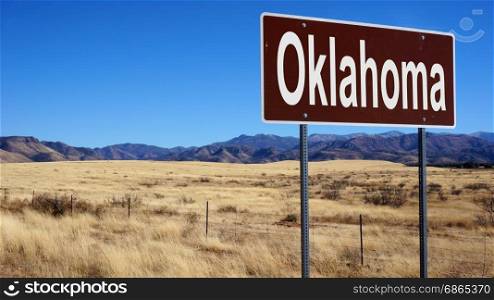 Oklahoma road sign with blue sky and wilderness