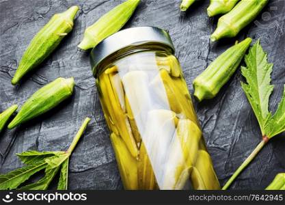 Okra pods canned in a glass jar.Homemade pickled salted vegetables.. Canned okra in jars