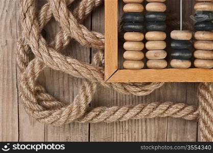 old abacus and rope on a wooden table
