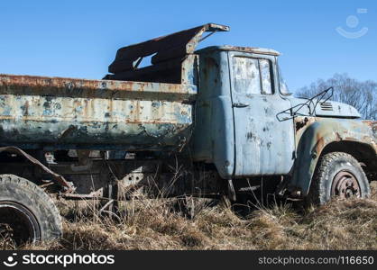 Old abandoned dirty broken vintage truck in the middle of paintball field playground