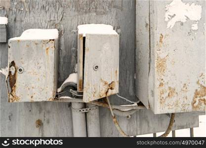 Old abandoned electricity boxes painted in gray color. Old abandoned electricity boxes painted in gray color.