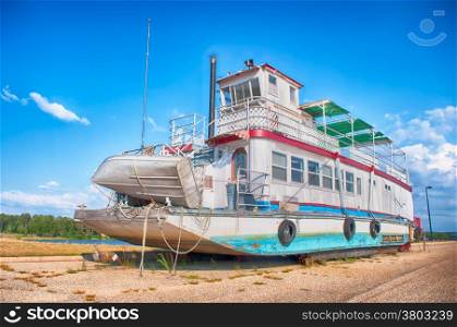 old abandoned ferry ship out of lake