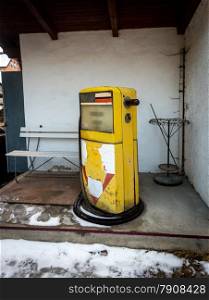 Old abandoned gas station with yellow pump