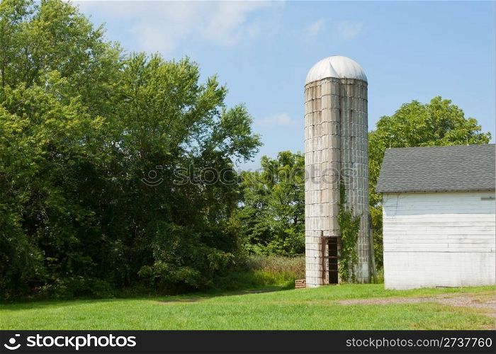 Old abandoned grain silo on the farmland.