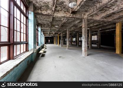 Old abandoned industrial interior with hall and big windows
