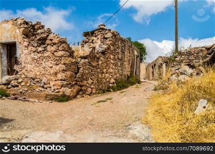 Old abandoned town. Narrow street in old Greek village. Traditional buildings. Destroyed house. Crete Island, Greece