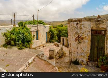 Old abandoned town. Narrow street in old Greek village. Traditional buildings. Destroyed house. Crete Island, Greece