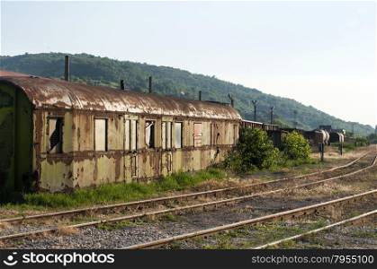 Old abandoned weathered grunge wagon near rail lines