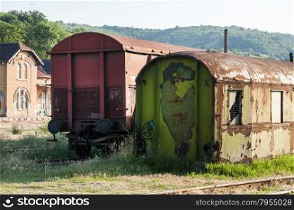 Old abandoned weathered grunge wagon near small railway station