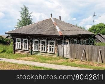 Old abandoned wooden house in russian village, sunny summer day