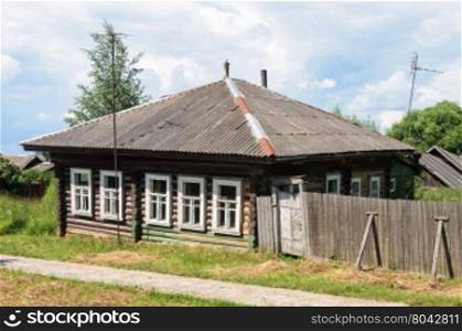 Old abandoned wooden house in russian village, sunny summer day