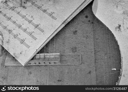 Old acoustic guitar and sheet music