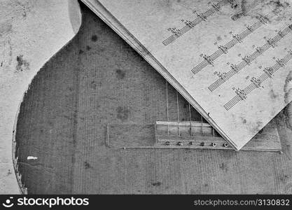 Old acoustic guitar and sheet music