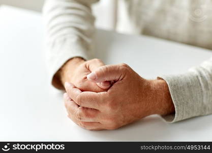 old age, gesture and people concept - close up of senior man hands on table. close up of senior man hands on table