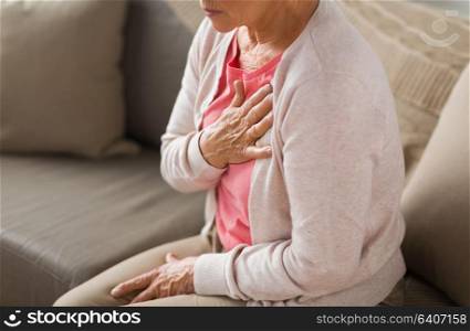 old age, health problem and people concept - close up of senior woman suffering from heartache at home. close up of senior woman having heartache at home