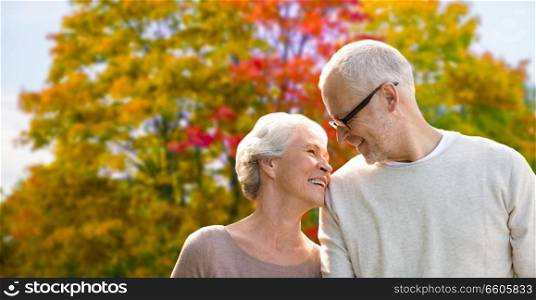old age, love and people concept - senior couple over autumn park background. senior couple over autumn park background